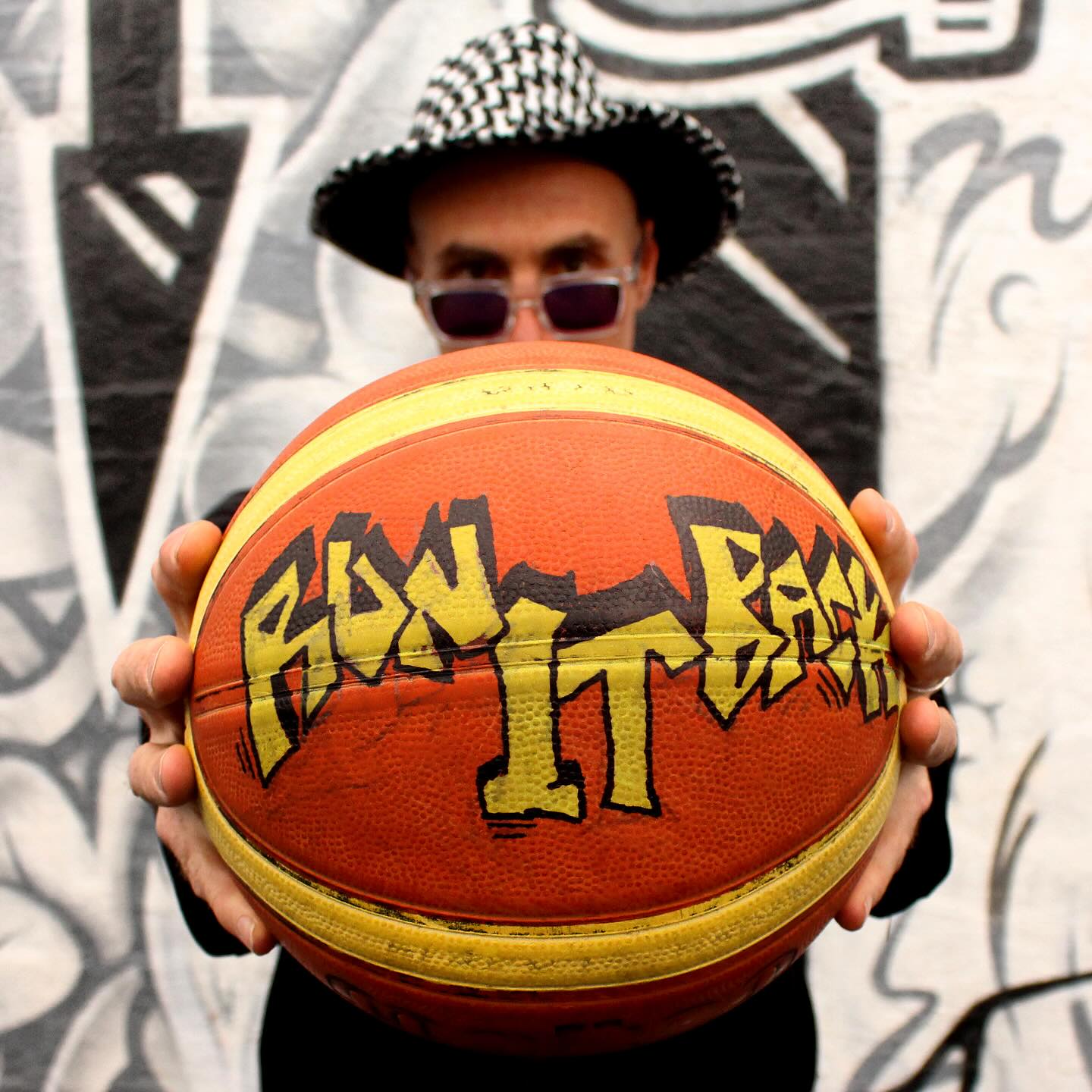Brian El Dorado holding a graffiti basketball — Run It Back single artwork